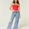 Jeans larghi a vita bassa e lavaggio medio con strappi curvy