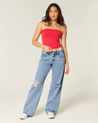 Jeans larghi a vita bassa e lavaggio medio con strappi curvy