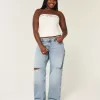 Jeans larghi a vita bassa e lavaggio medio con strappi curvy Jeans larghi a vita bassa e lavaggio medio con strappi curvy