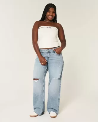 Jeans larghi a vita bassa e lavaggio medio con strappi curvy
