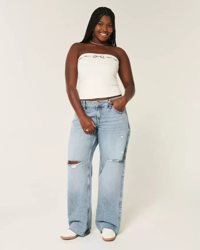 Jeans larghi a vita bassa e lavaggio medio con strappi curvy Jeans larghi a vita bassa e lavaggio medio con strappi curvy