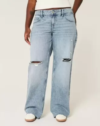 Jeans larghi a vita bassa e lavaggio medio con strappi curvy