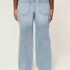 Jeans larghi a vita bassa e lavaggio medio con strappi curvy Jeans larghi a vita bassa e lavaggio medio con strappi curvy