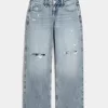 Jeans larghi a vita bassa e lavaggio medio con strappi curvy Jeans larghi a vita bassa e lavaggio medio con strappi curvy