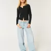 Jeans larghi affusolati a vita bassa con lavaggio medio Jeans larghi affusolati a vita bassa con lavaggio medio