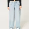 Jeans larghi affusolati a vita bassa con lavaggio medio Jeans larghi affusolati a vita bassa con lavaggio medio