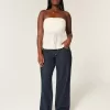 Jeans larghi con risvolto e vita bassa e lavaggio scuro