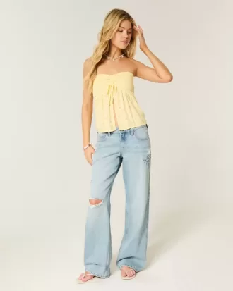 Jeans larghi con stampa grafica e lavaggio chiaro strappati a vita bassa