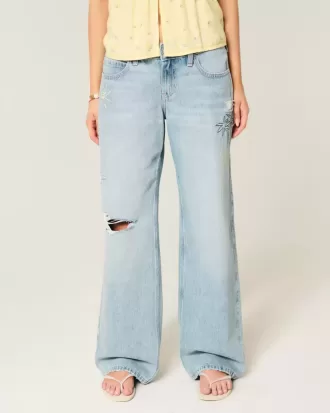Jeans larghi con stampa grafica e lavaggio chiaro strappati a vita bassa