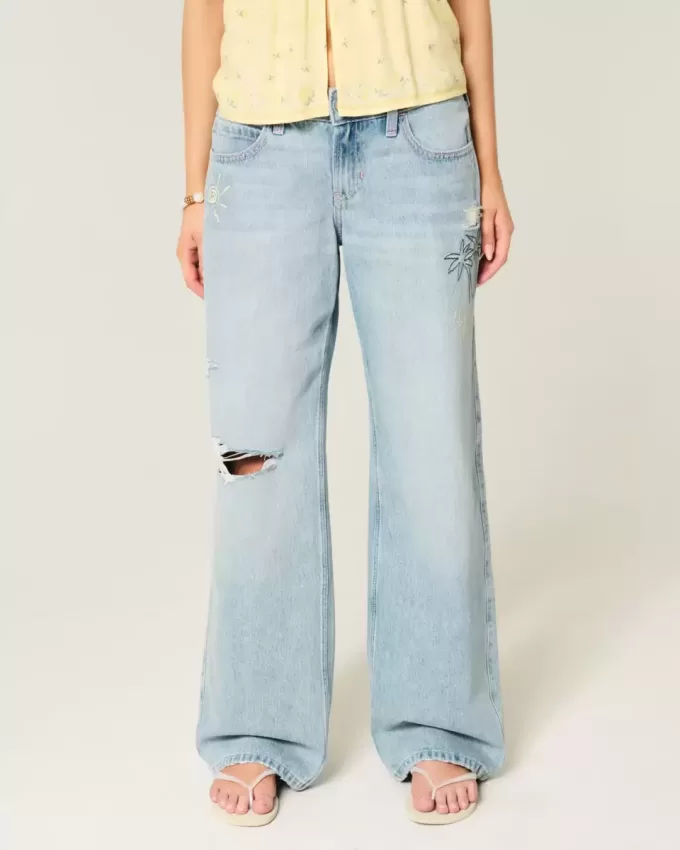 Jeans larghi con stampa grafica e lavaggio chiaro strappati a vita bassa