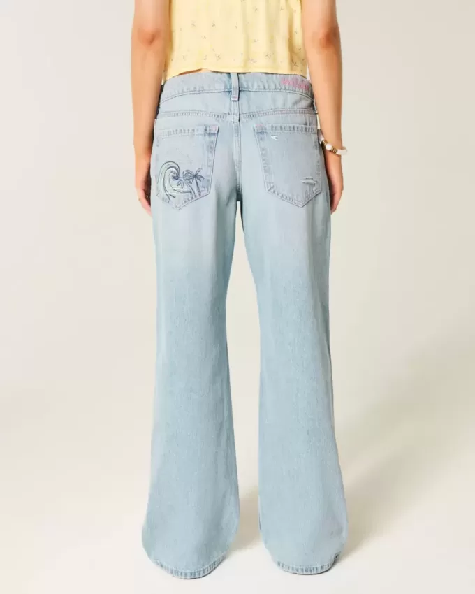 Jeans larghi con stampa grafica e lavaggio chiaro strappati a vita bassa