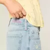 Jeans larghi con stampa grafica e lavaggio chiaro strappati a vita bassa