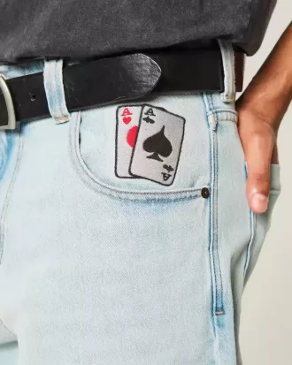 Jeans larghi da skater con grafica di carte da gioco e lavaggio chiaro
