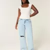 Jeans larghi e strappati a vita bassa con lavaggio chiaro