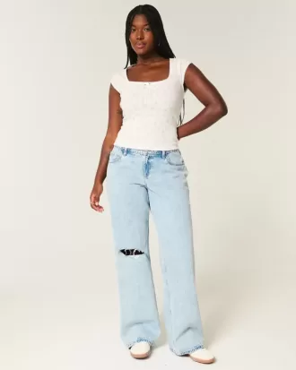 Jeans larghi e strappati a vita bassa con lavaggio chiaro