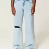 Jeans larghi e strappati a vita bassa con lavaggio chiaro