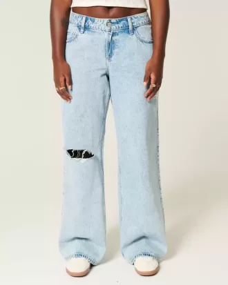 Jeans larghi e strappati a vita bassa con lavaggio chiaro