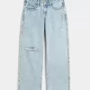Jeans larghi e strappati a vita bassa con lavaggio chiaro