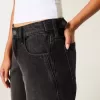Jeans larghi neri lavati a vita bassa e regolabile