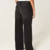 Jeans larghi neri lavati a vita bassa e regolabile