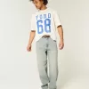 Jeans larghi skater con dadi ricamati e lavaggio chiaro