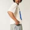 Jeans larghi skater con dadi ricamati e lavaggio chiaro