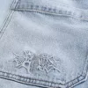 Jeans larghi skater con lavaggio chiaro ricamati