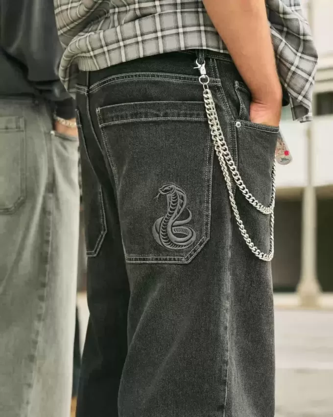 Jeans larghi skater con ricamo serpente nero lavato