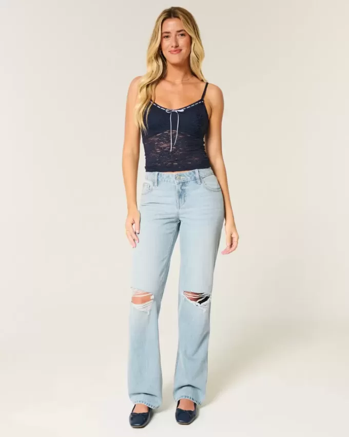 Jeans larghi strappati e lavaggio chiaro a vita bassa Jeans larghi strappati e lavaggio chiaro a vita bassa