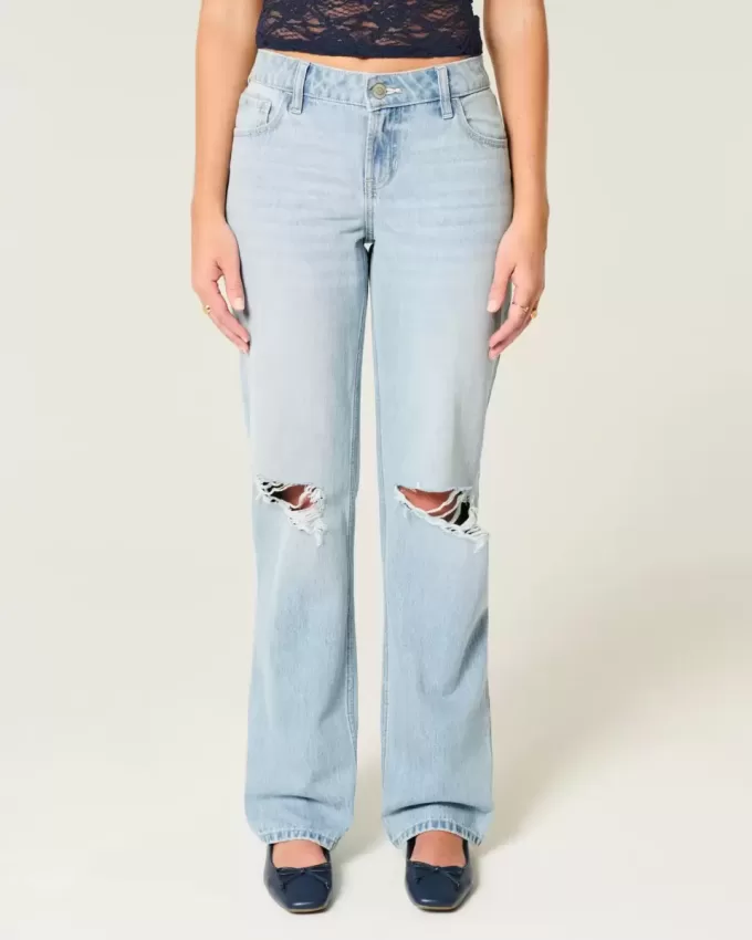 Jeans larghi strappati e lavaggio chiaro a vita bassa Jeans larghi strappati e lavaggio chiaro a vita bassa