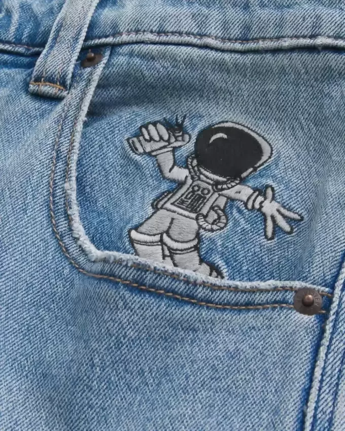 Jeans super larghi con grafica astronauta lavaggio chiaro