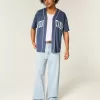 Jeans super larghi con grafica New York e lavaggio chiaro
