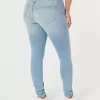 Jeans super skinny a vita alta con lavaggio medio e curve