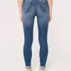 Jeans super skinny a vita alta con strappi e lavaggio medio
