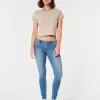 Jeans super skinny a vita bassa e lavaggio medio con effetto curvy