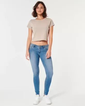 Jeans super skinny a vita bassa e lavaggio medio con effetto curvy