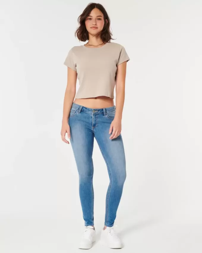 Jeans super skinny a vita bassa e lavaggio medio con effetto curvy