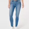 Jeans super skinny a vita bassa e lavaggio medio con effetto curvy