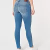 Jeans super skinny a vita bassa e lavaggio medio con effetto curvy