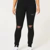 Jeans super skinny neri strappati a vita alta