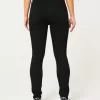 Jeans super skinny neri strappati a vita alta