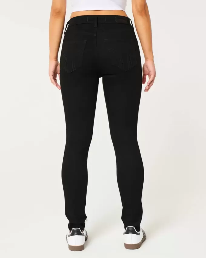 Jeans super skinny neri strappati a vita alta