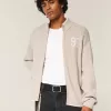Maglione con cerniera e grafica numerica rilassata