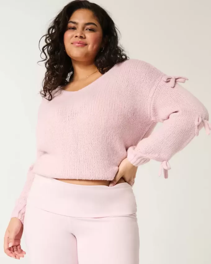Maglione con fiocco applicato a spalle scoperte Maglione con fiocco applicato a spalle scoperte