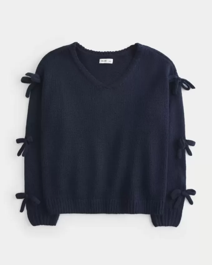 Maglione con fiocco applicato a spalle scoperte Maglione con fiocco applicato a spalle scoperte