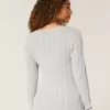 Maglione con scollo a V e lavorazione a trecce