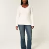 Maglione con scollo a V e lavorazione a trecce