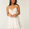 Mini abito in chiffon con orlo asimmetrico