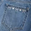 Mini gonna-pantalone in denim a vita bassa con fiocco ricamato