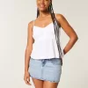 Mini gonna-pantalone in denim a vita bassa e sinuosa